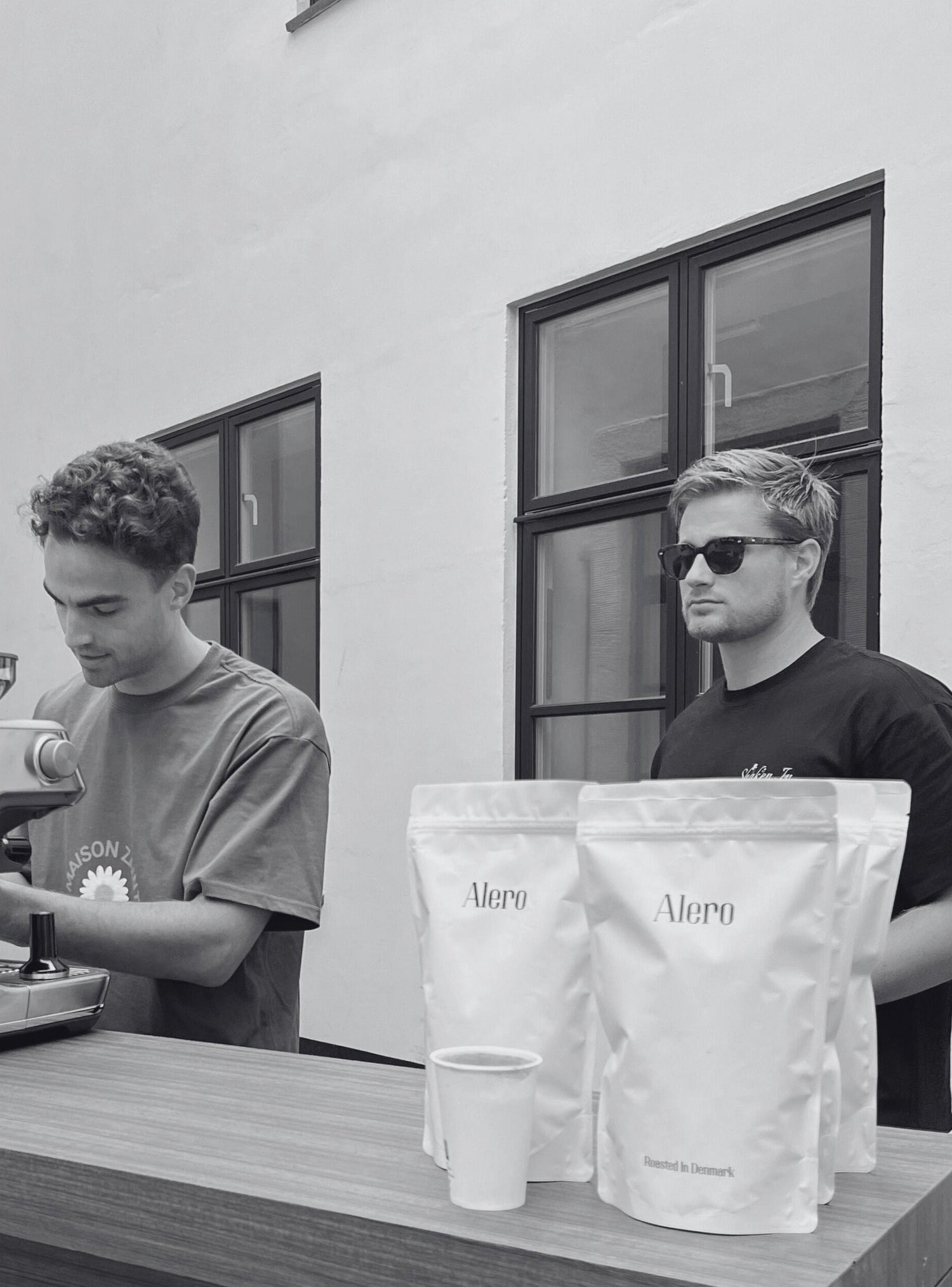 Image of Alero Team Members behind the coffee bar at the Alero Coffee Pop Up Event in Copenhagen